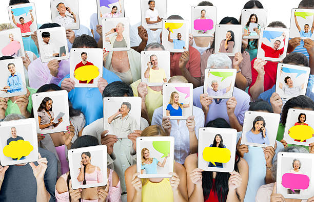 istock Multi-ethnic group of people holding tablets in front of the faces 474070865
