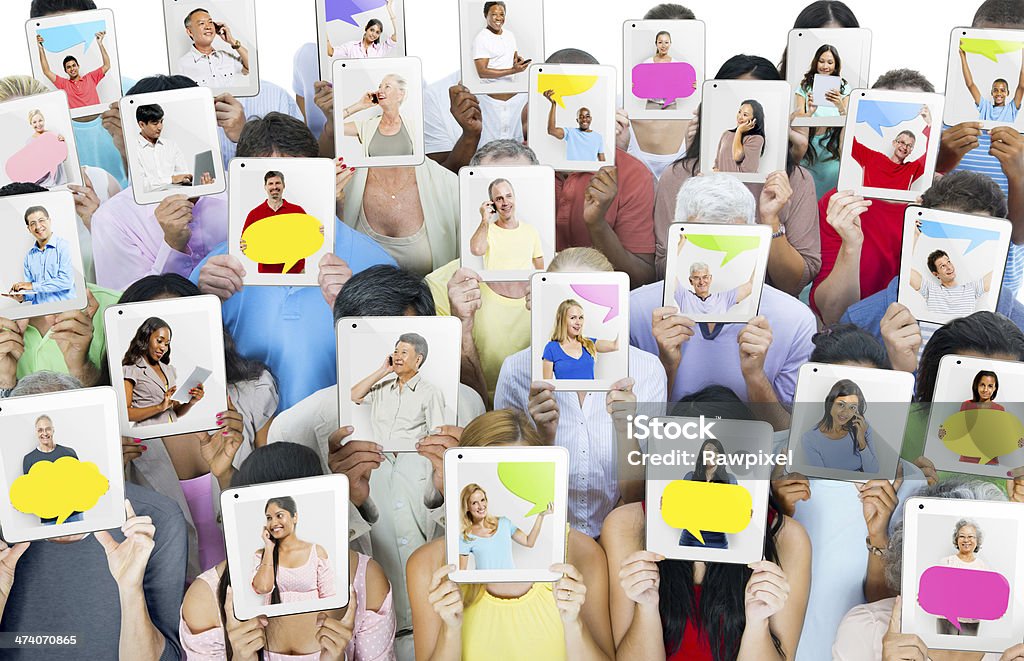 Multi-ethnic group of people holding tablets in front of the faces  Digital Tablet Stock Photo