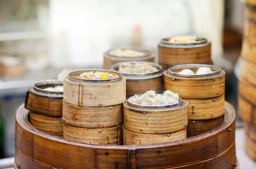 Dim Sum mix steamed in bamboo  wood basket.large range of small Chinese dishes that are traditionally enjoyed in restaurants for brunch