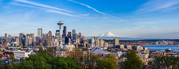 Seattle downtown skyline and Mt. Rainier, Washington Panorama view of Seattle downtown skyline and Mt. Rainier, Washington. mt rainier stock pictures, royalty-free photos & images