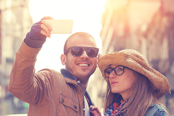 istock Attractive couple doing selfie outdoors 474073460