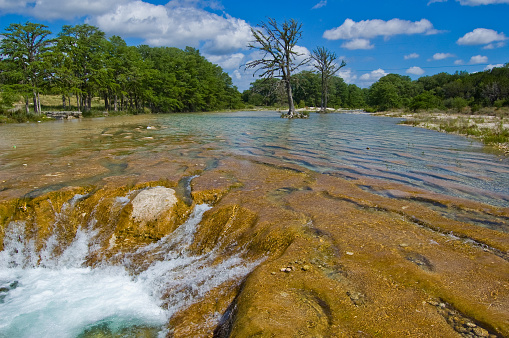 Looking down over the Guadalupe river in downtown Kerrville Texas. Walking trails and bridges along the river running through the Texas hill country in springtime.