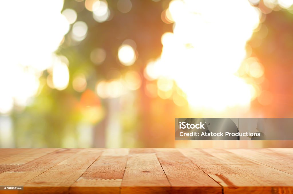 Wood table top on shiny sunlight bokeh background Wood table top on shiny sunlight bokeh background - can used for display or montage your products Table Stock Photo