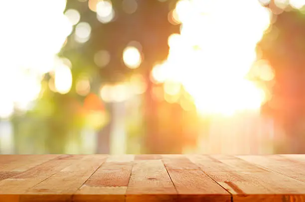 Photo of Wood table top on shiny sunlight bokeh background