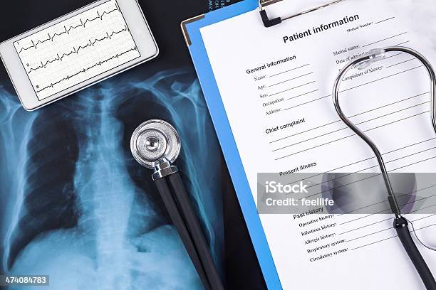 Various Medical Items Such As An Xray Chart And Tablet Stock Photo - Download Image Now