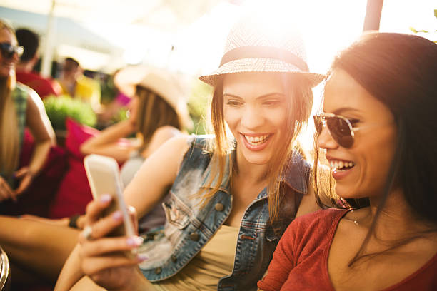 istock Young happy women using smart phone in a cafe. 474084816