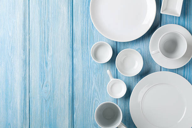 istock Empty plates and bowls on blue wooden background 474087680