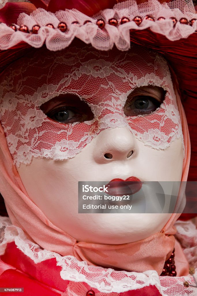 Venetian carnival mask Venice, Italy - February 10, 2013: Unidentified person with traditional Venetian carnival mask in Venice, Italy. At 2013 it is held from January 26th to February 12th. Abstract Stock Photo