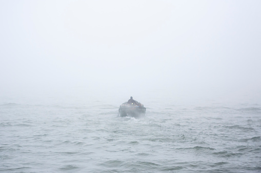 boat in the ocean in the fog