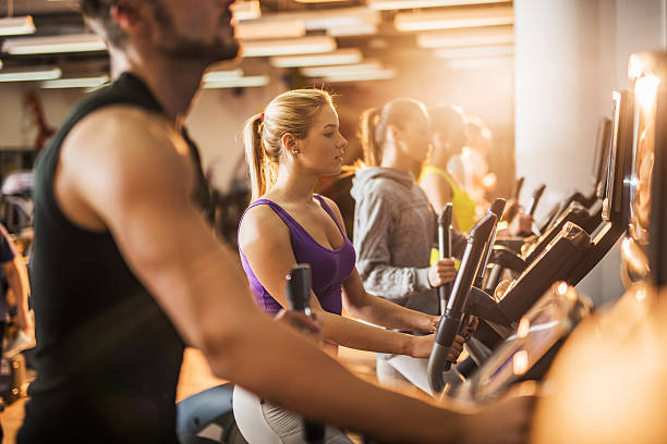 istock Group of people exercising on exercise machine in a gym. 474091786