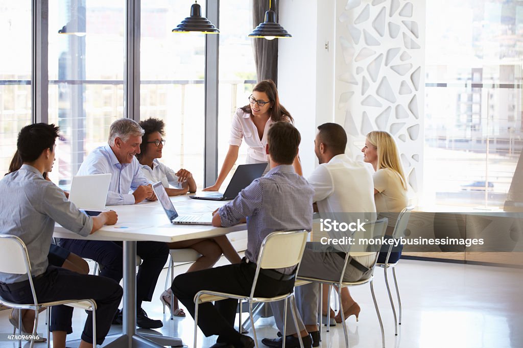 Businesswoman presenting to colleagues at a meeting Leadership Stock Photo