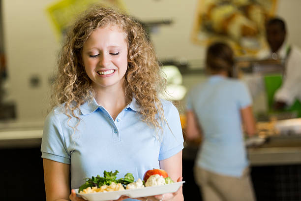 istock Student in private high school cafeteria is disgusted by food 474097030