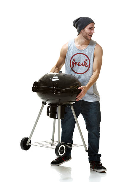 istock Smiling man holding Barbecue Grill 474099553