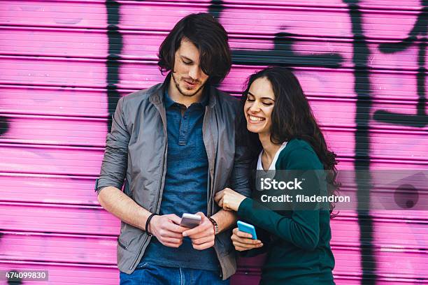 Young Couple Chatting On The Phone Stock Photo - Download Image Now - Couple - Relationship, Portrait, 20-29 Years