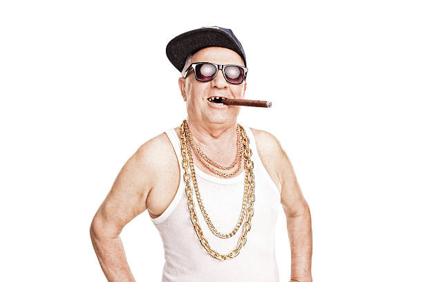 istock Toothless senior with a hip-hop cap smoking cigar 474099932