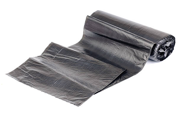 istock roll of black garbage bags on a white background 474101681