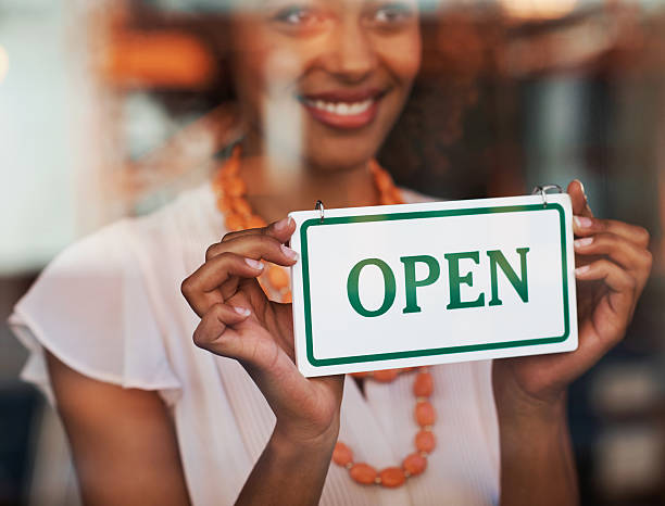 istock Smiling woman holding come in sign 474104269