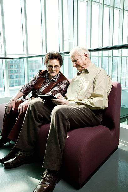 istock senior man showing his wife tablet pc 474106865