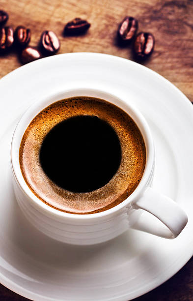 istock Coffee cup with roasted cofee beans  on wooden background, 474107035