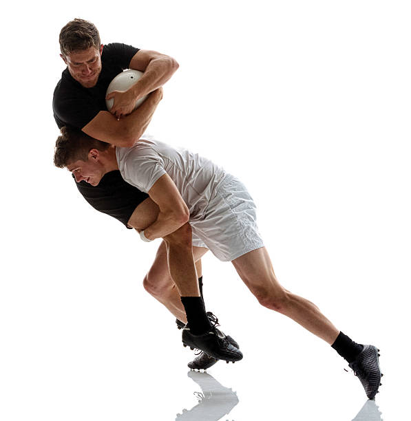 A rugby game mid action with the one team member scoring a try