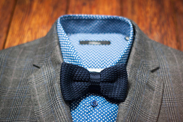 Men's suit with a stylish modern bow tie on the wooden background