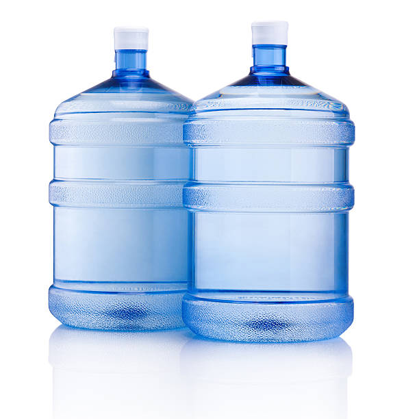 deux grandes bouteilles d'eau isolé sur fond blanc - brand named water photos et images de collection