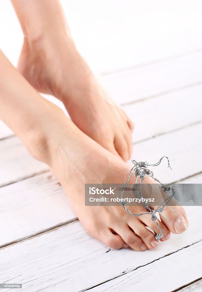 Healthy feet, pedicure The rate of women wrapped in barbed wire, symbol of the pain of injury Ingrown Nail Stock Photo