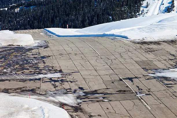 Plane landing on Courchevel airport in the French Alps, plenty of snow. Courchevel, Les 3 Vallees, France