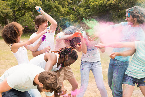 istock Happy friends throwing powder paint 474116446