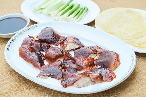 beijing roasted duck in a set with pancake, spring onion, cucumber and sweet sauce