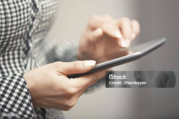 Womanworking With Digital Tablet Indoors Stock Photo - Download Image Now - 2015, Computer, Digital Tablet