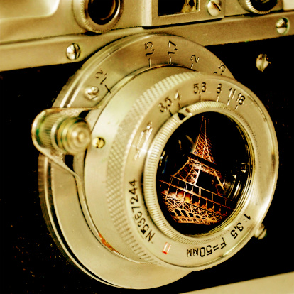 Eiffel tower reflection in old camera lens.