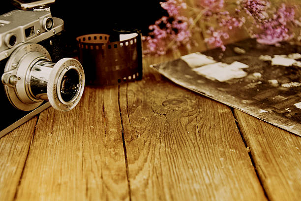 Old camera on the wooden table.