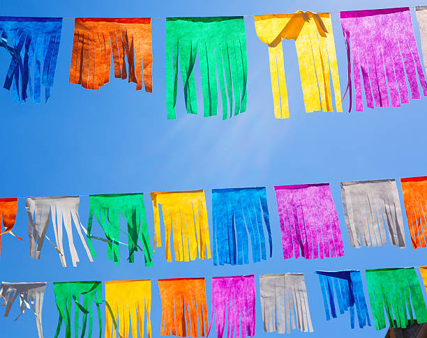 istock colorful tissue Paper fringe garland under blue sky 474125384
