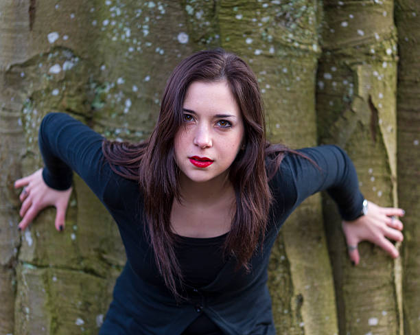 istock Pretty Young Girl with Intense Expression in Front of Tree 474126895