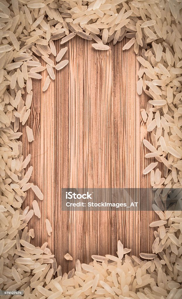 Rice frame on wooden table Rice on wooden table. Photo made in hq studio.  2015 Stock Photo