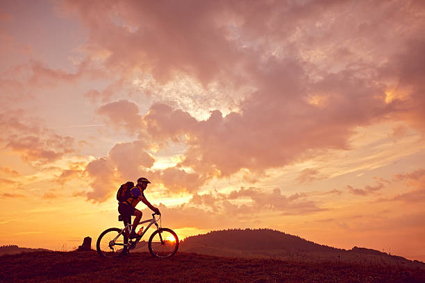 istock Man mountain biking sunny side view 474127494