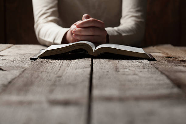 woman finger presses on bible book