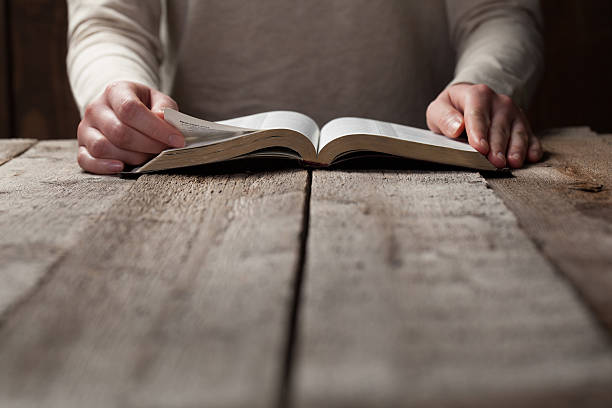 istock A woman reading her bible at a table  474127852