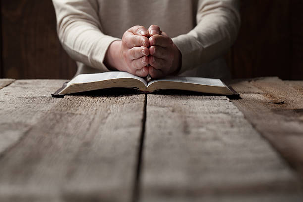 istock woman finger presses on bible book 474127956
