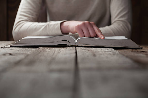 istock woman hands on bible. 474128210