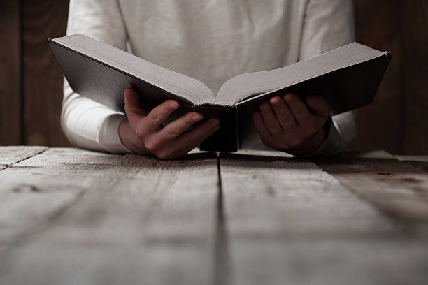 istock woman hands on bible. 474128232