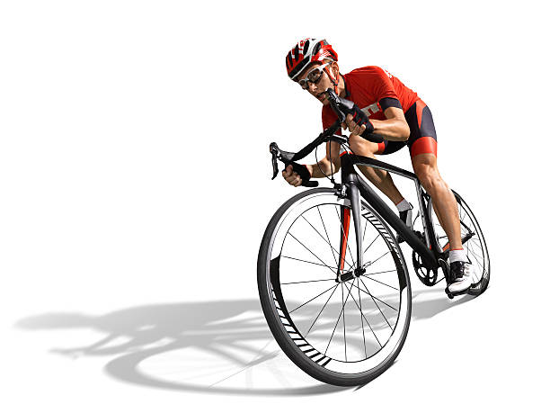 Male cyclist in red biking outfit and helmet racing his bike stock photo