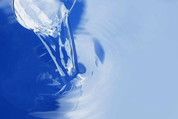 Blue transparent glasses stacked together creating an abstract pattern with reflections and light distortion.