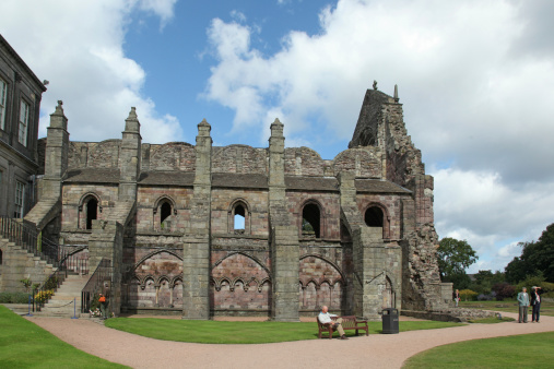 Edinburgh, Scotland - August 31, 2013: Some people visit Holyrood Abbey. The abbey dates from the 12th century and has been in ruins since the 18th century