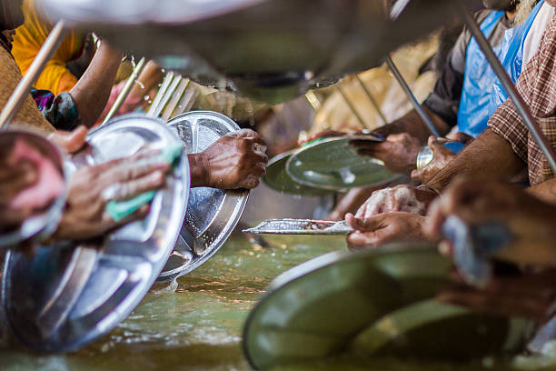 istock Sikh devotees performing bartan seva at Golden temple, Amritsar 474138102