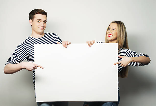 istock Couple holding a banner 474142978