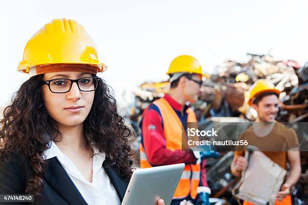 Portrait Of Young Famale Architect At Work On Site Stock Photo - Download Image Now - Hardhat, Scrap Metal, 2015