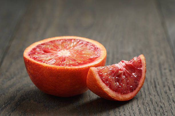 istock half and section of red orange on wooden table 474151306