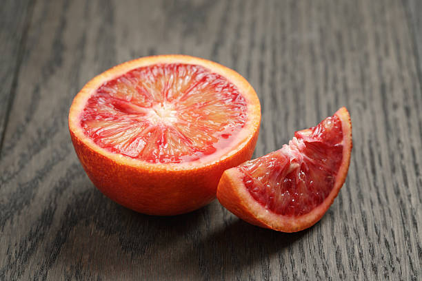istock half and section of red orange on wooden table 474151308